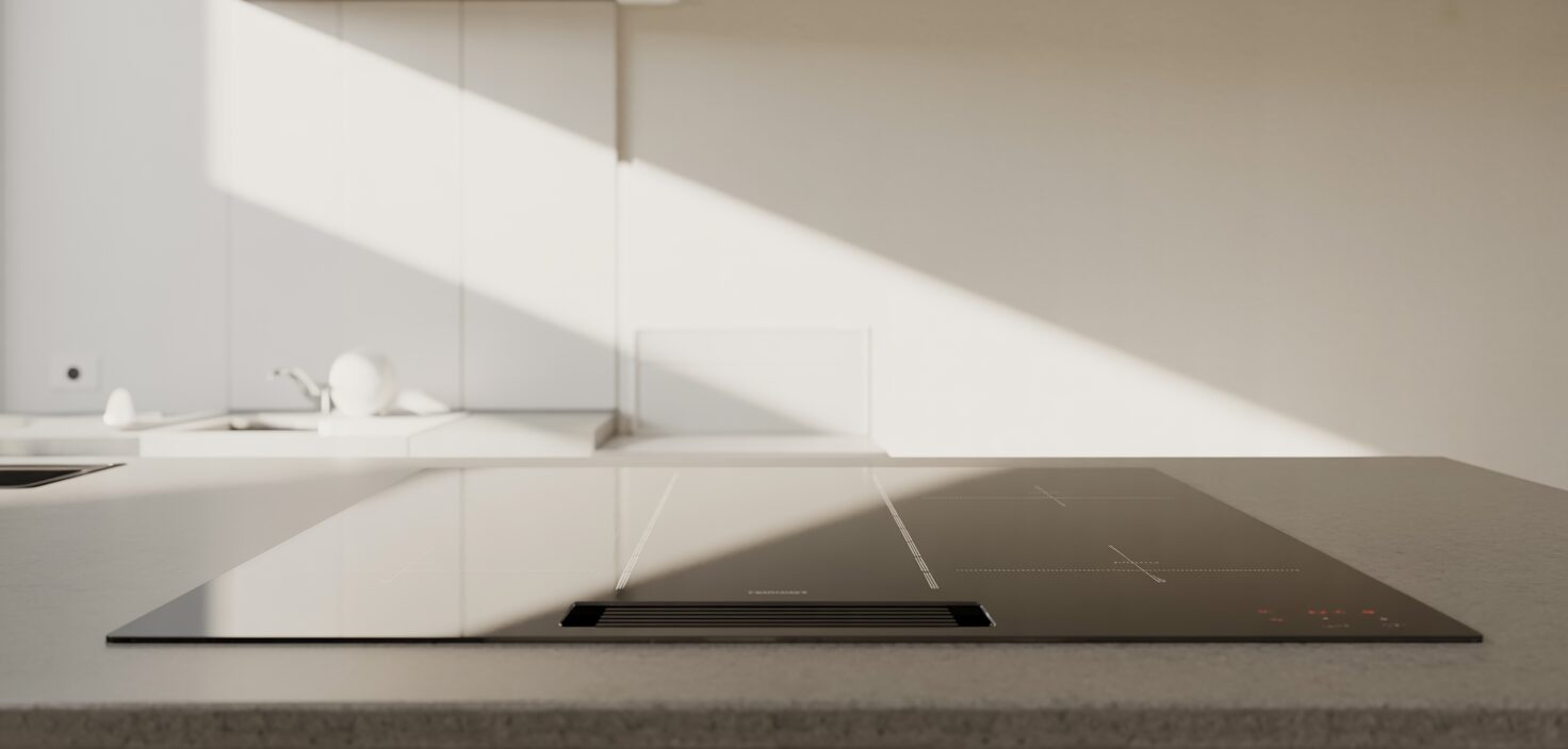 En ultra-minimalistisk induktionshäll av glas, skinande ren och speglande ljuset i ett minimalistiskt kök.